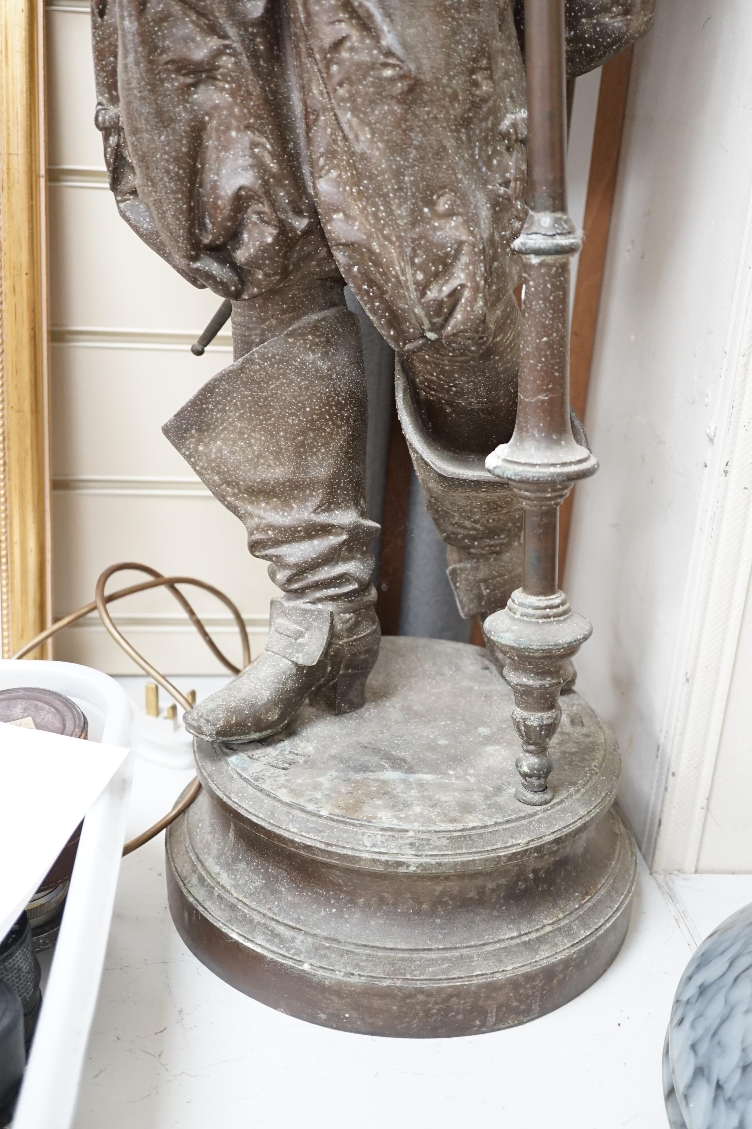 A 20th century spelter figural Cavalier floor lamp, with glass torch shade, approximately 108cm high